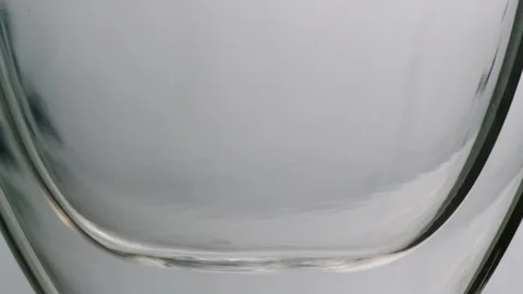 Hot tea whirling inside a tea glass in slowmotion Stock Footage 99701546