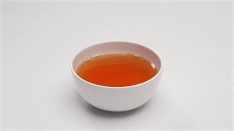 Hot Tea in White Ceramic Bowl on White Background Stock Footage 336706932