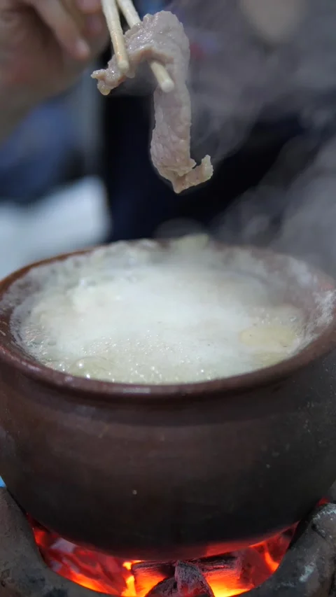 Hot Thai beef slice in boiling clay pot Stock Footage 320768861