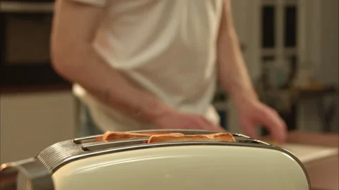 Hot toast bread is jumping from the toaster. man cook his own breakfast Stock-Footage 196407734