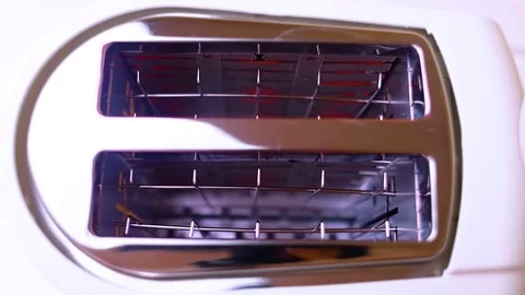 Hot toaster. Top view of an electric appliance for frying bread. Close-up of hea Video stock 248596528