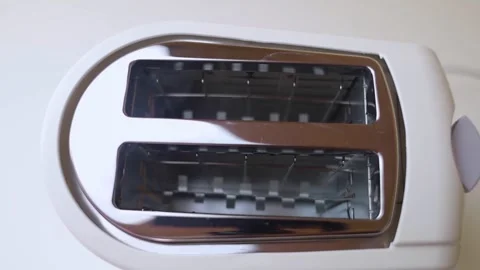 Hot toaster. Top view of an electric appliance for frying bread. Close-up of hea Video stock 248596548