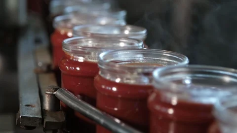 Hot tomato paste banks running on a metallic stripe without lids in tomato Stock-Footage 118424087