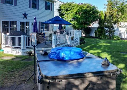 Hot Tub on a Deck With Yard Space and Patio Furniture in a Backyard Stock Photos