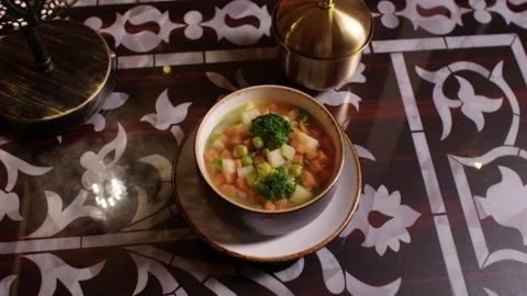 Hot Turkish vegetable soup steaming on a traditional Arabic restaurant table Stockbeeldmateriaal 345133986