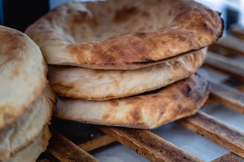 Hot Uzbek flatbread with appetizing crust Stock Photos