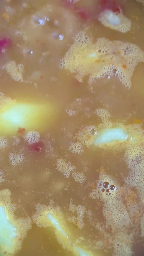 Hot vegetable soup simmering with potatoes and tomatoes bubbling Stock Footage 331974523