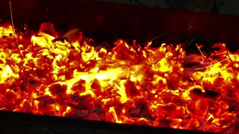 Hot warming red burning fire in fireplace, close up. Flame of bonfire radiates e Stock Footage 250159748
