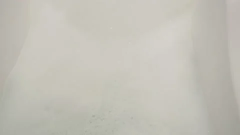 Hot water for bathing, fluffy white foam is drawn from the tap into the bath 库存影片 150517938