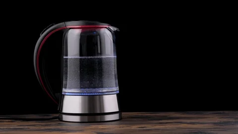 Hot water begins to boil in kettle. Electric kettle Stock Footage