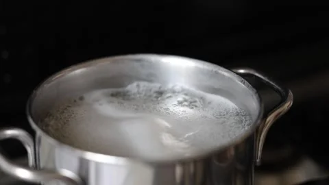 Hot water is boiling in a pot Stock Footage 345937623