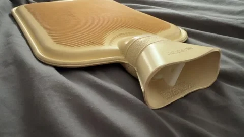 Hot water bottle heating portable device in the winter Stock Footage 342469383