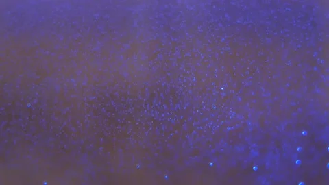 Hot water bubbles inside kettle with violet reflective light. 库存影片 151154274