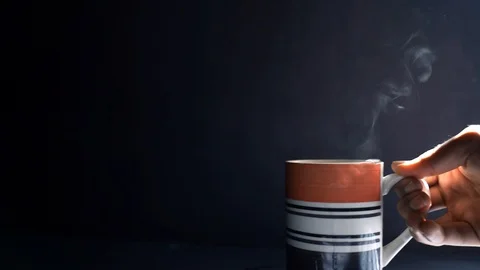 Hot water falling from the cup while mixing Stock Footage 121580764