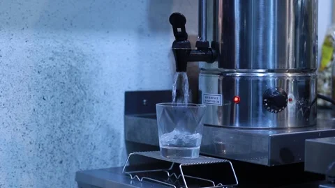 Hot water flows into a transparent glass, boiling water pours into a cup in the Stock Footage 166644618