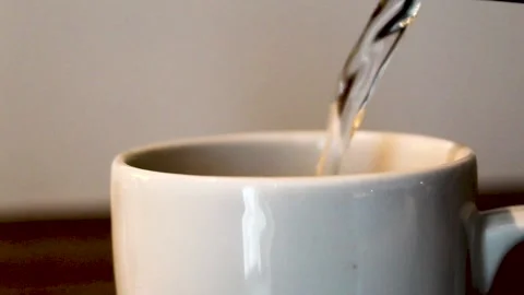 Hot water pouring into mug Stock Footage