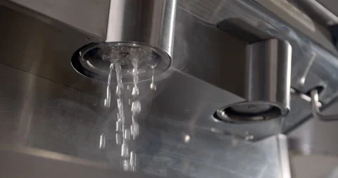 Hot water running from coffee machine one cup portafilter. Cleaning process in Stock Footage 131127376