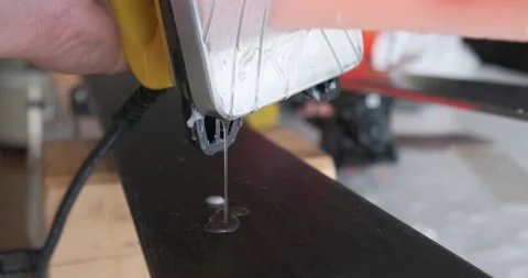 Hot wax drips on ski base. Wax bar melts against hot iron. DIY ski tuning. Video stock 140211332