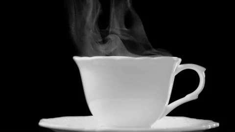 Hot white tea or coffee cup against black background. Slow motion shot Stock Footage 150306130