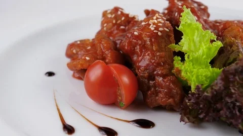Hot wings or Fried chicken wings, served in Restaurant Stock Footage 80143186