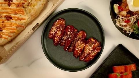 Hot wings spin on a plate Stock Footage 323388801