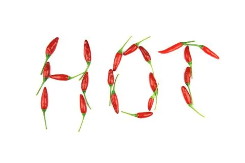 Hot word made from red chilli peppers on white background. Stock Photos