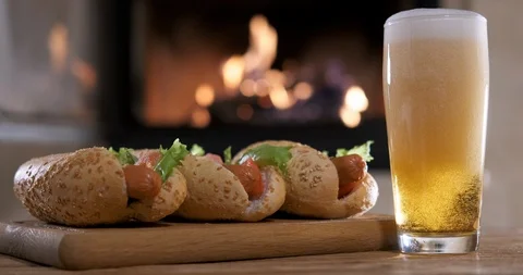 Hotdogs with beer on the fireplace background. 動画素材 100413666