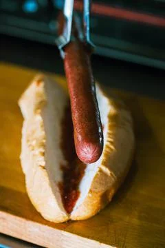 Hotdogs in making. Close up. Stock Photos