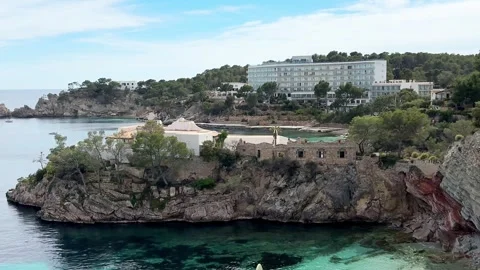 Hotel and coastal cliffs overlooking the Mediterranean sea in Cala Fornells Stock Footage 341309733