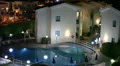 Hotel area with illuminated swimming pool HD Footage