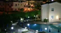 Hotel area review with illuminated blue swimming pool HD Footage