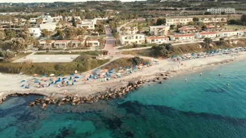 Hotel Beach front at sunset on Kos with tourists Stock Footage 137709280