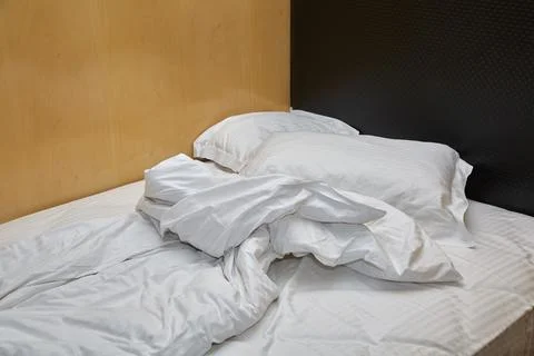Hotel bed closeup Stock Photos