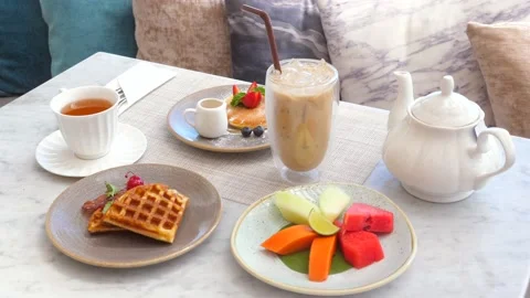Hotel breakfast includes refreshing iced coffee, colorful fresh fruits Stock Footage 231202536