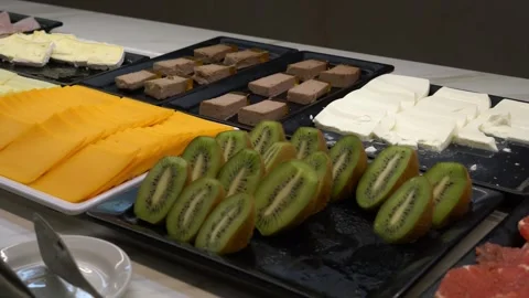 Hotel buffet counter with cheese kiwi and snacks on serving trays 스톡 동영상 341809676