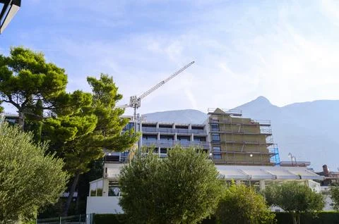 Hotel building facade under construction with a tall crane and scaffolding on a Stock Photos