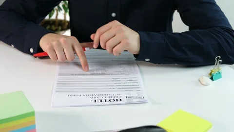 The hotel check-in form that the client studies before checking in at the office Stock Footage 313046285