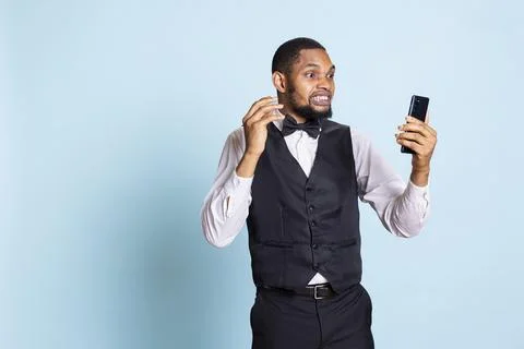 Hotel concierge chatting with guests on videoconference call Stock Photos