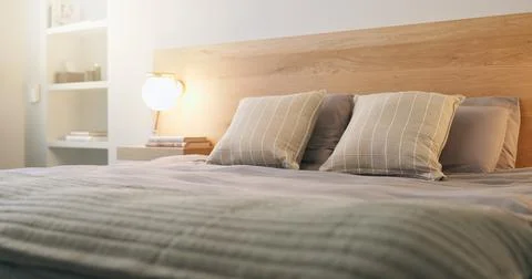 Hotel, empty and bed with light for accommodation, furniture and interior d.. Stock Photos