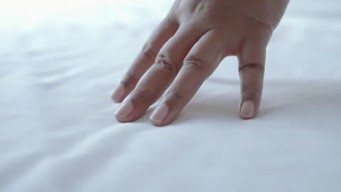Hotel housekeeper is making the bed and arranging the pillows. Stock Footage 275367576