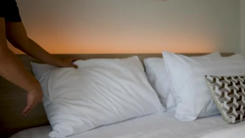 Hotel Housekeeper Making Bed and Arranging Pillows in Room Stock Footage 346016586
