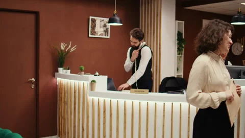 Hotel manager taking guest feedback Stock Footage 243630594