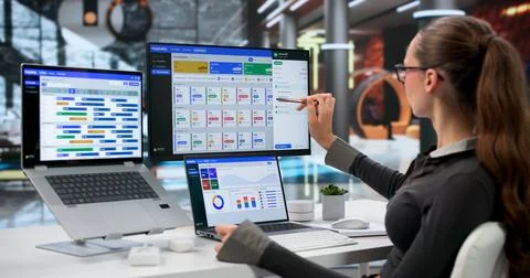 Hotel Manager Updates Room Availability Using Laptop For Guest Bookings. Stock Photos