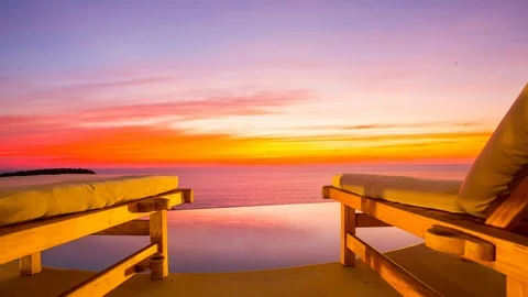Hotel pool sunbed with timelapse of the sunset at mexican coast Stockbeeldmateriaal 100095347