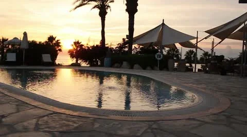 Hotel pool at sunset Stock Footage 20588912