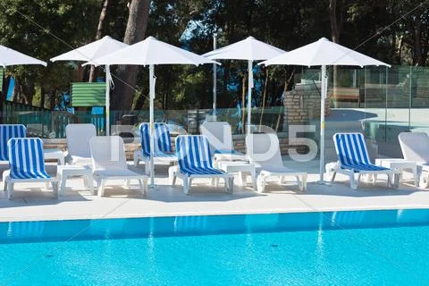 Hotel Poolside Chairs with Sea view Stock Photos