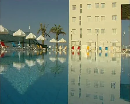 Hotel reflection empty pool area at a hotel north of Famagusta Cyprus 16:9 PAL Stock Footage 20618950