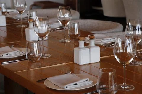 Hotel restaurant style dining table set up with wine glass and cutlery etc Stock Photos