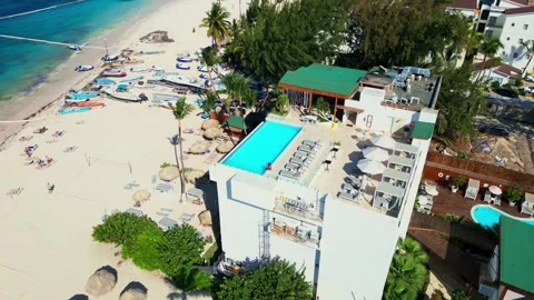 A hotel with a rooftop pool on the oceanfront. Bright sunny day in Punta Cana Stock Footage 311340231
