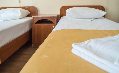 Hotel room with two empty SINGLE beds and bedside tables, the concept of the  Stock-Fotos
